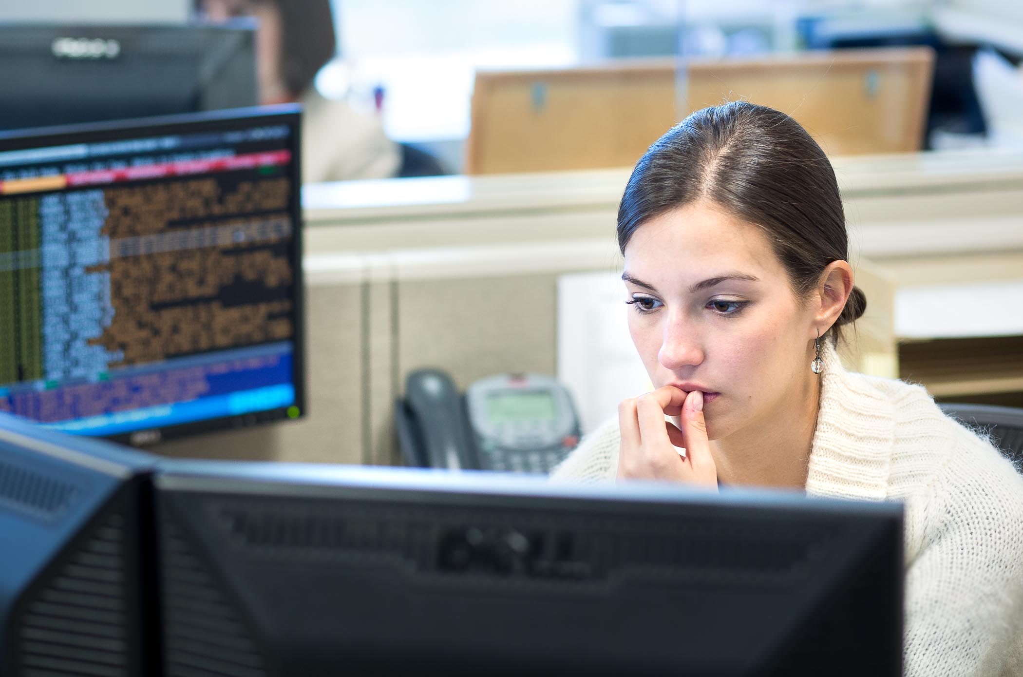 Candid photo of woman at desk reviewing stock trades by Atlanta photographer