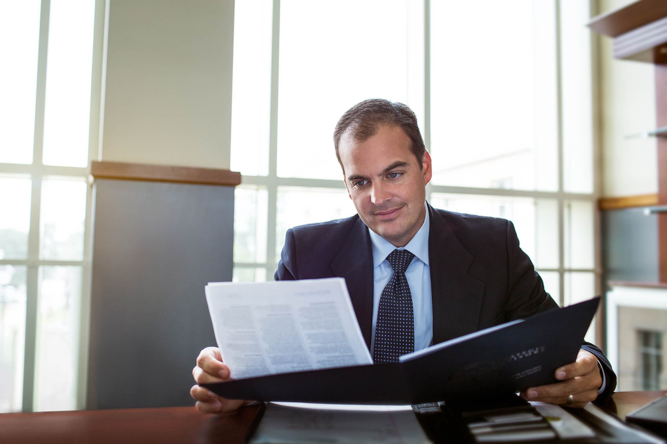 Atlanta Lawyer Reviewing a Document While Photographed
