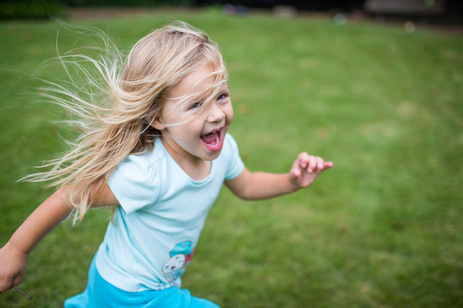 Girl Running in Grass by Atlanta Lifestyle Photographer